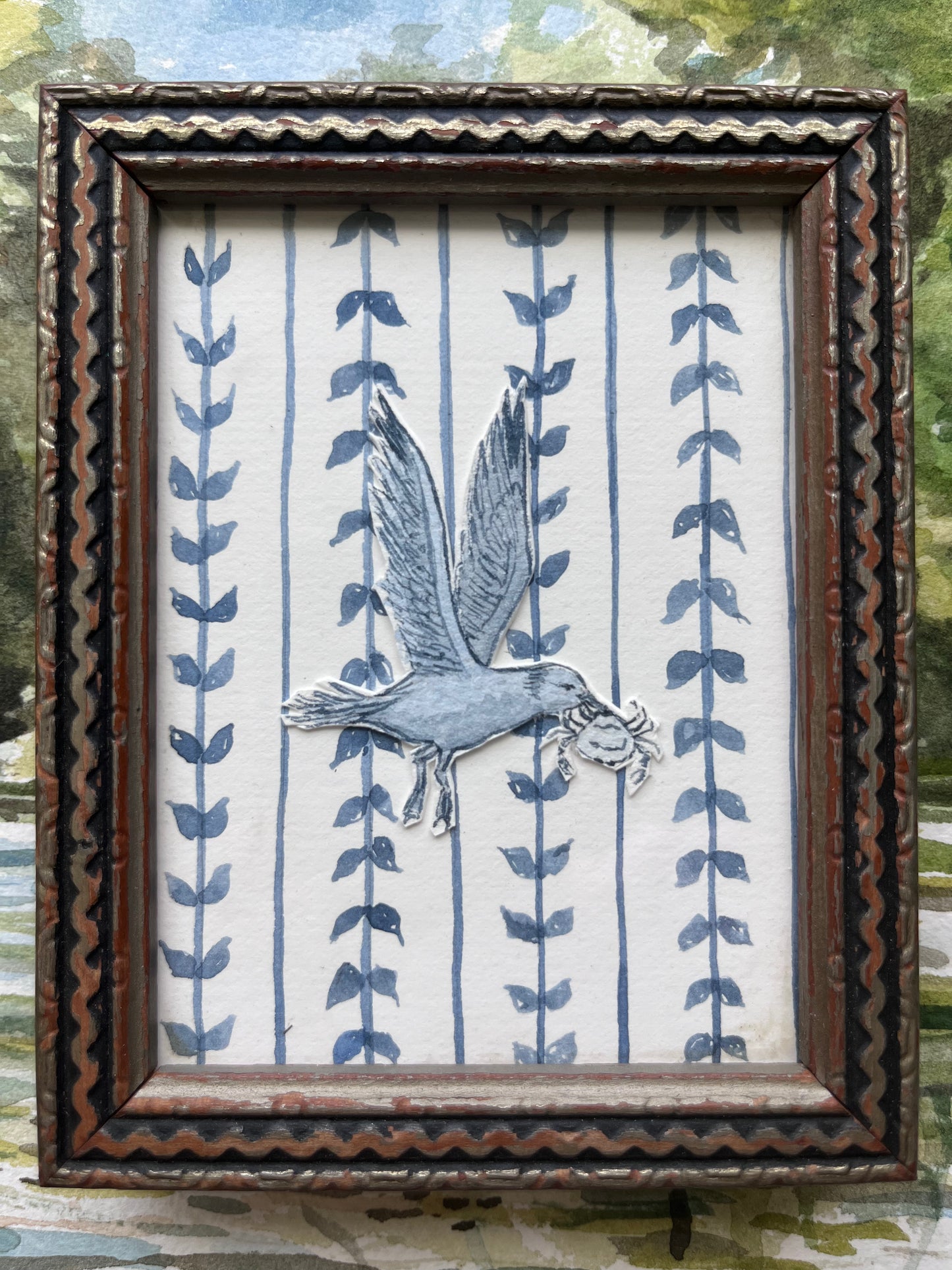 Dusty blue hand-painted watercolor gull carrying crab.