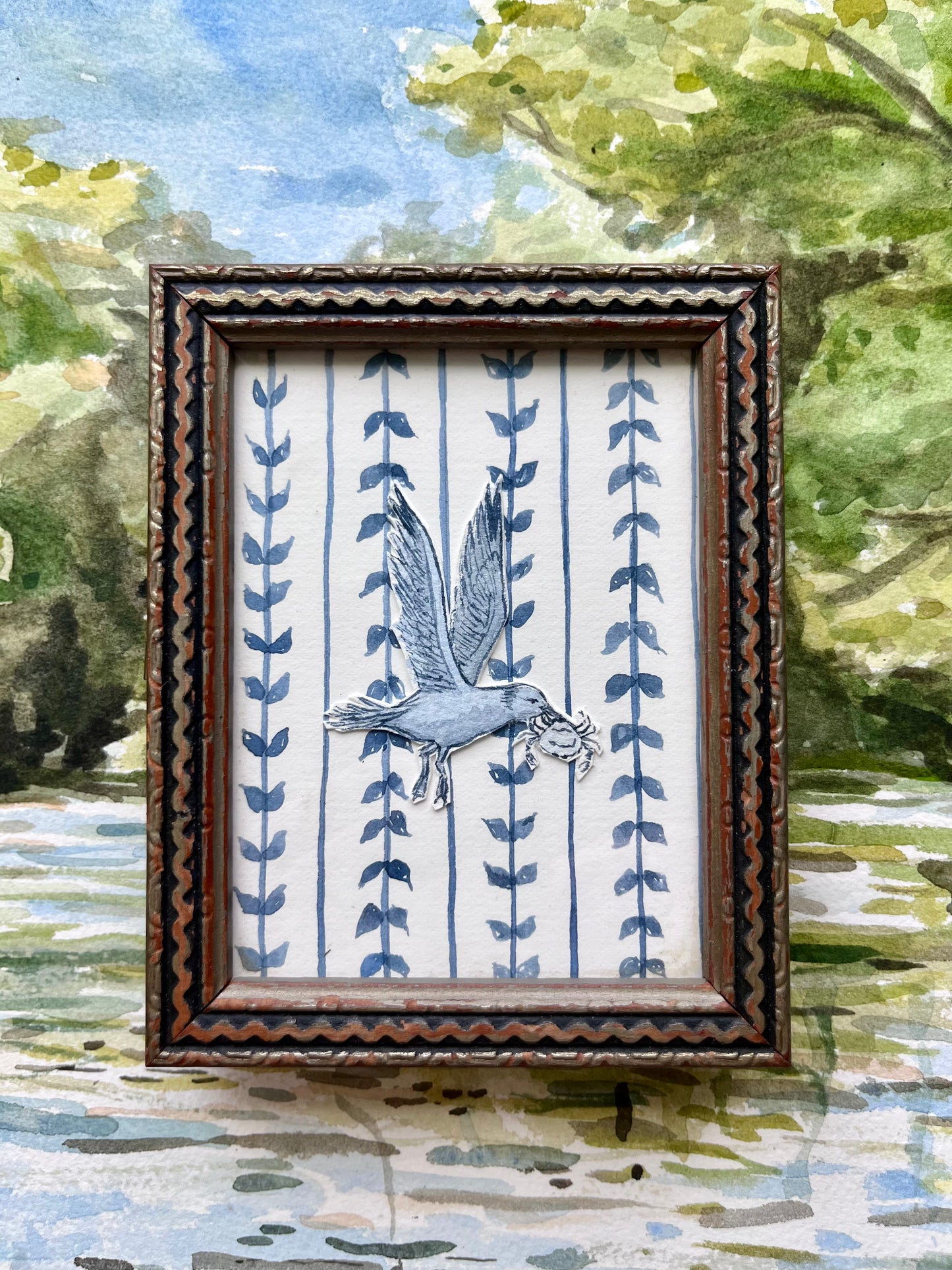 Dusty blue hand-painted watercolor gull carrying crab.