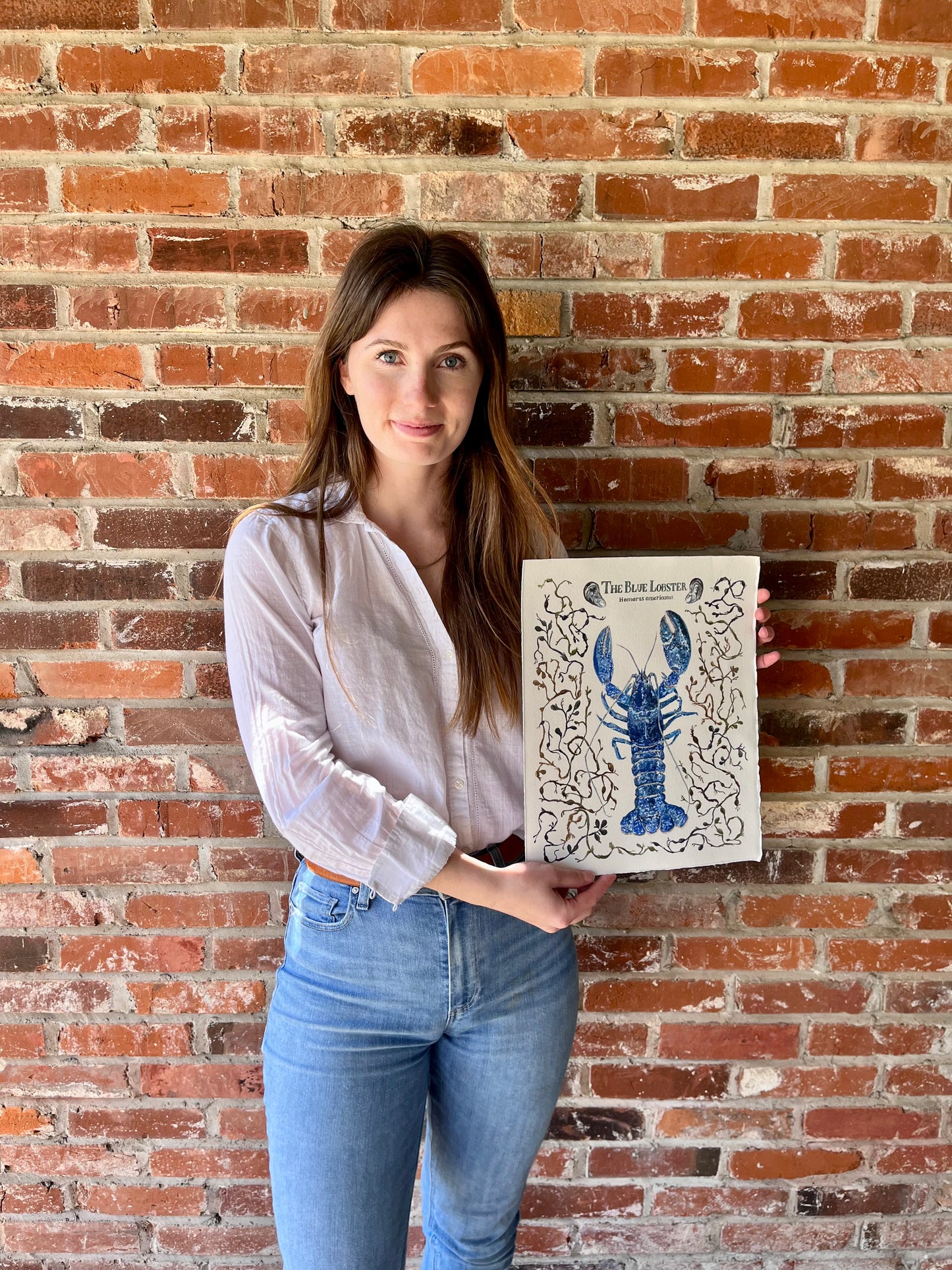 Original Fine art Blue Lobster surrounded by seaweed and clams held by artist Josephine Tarbell Toepfer.
