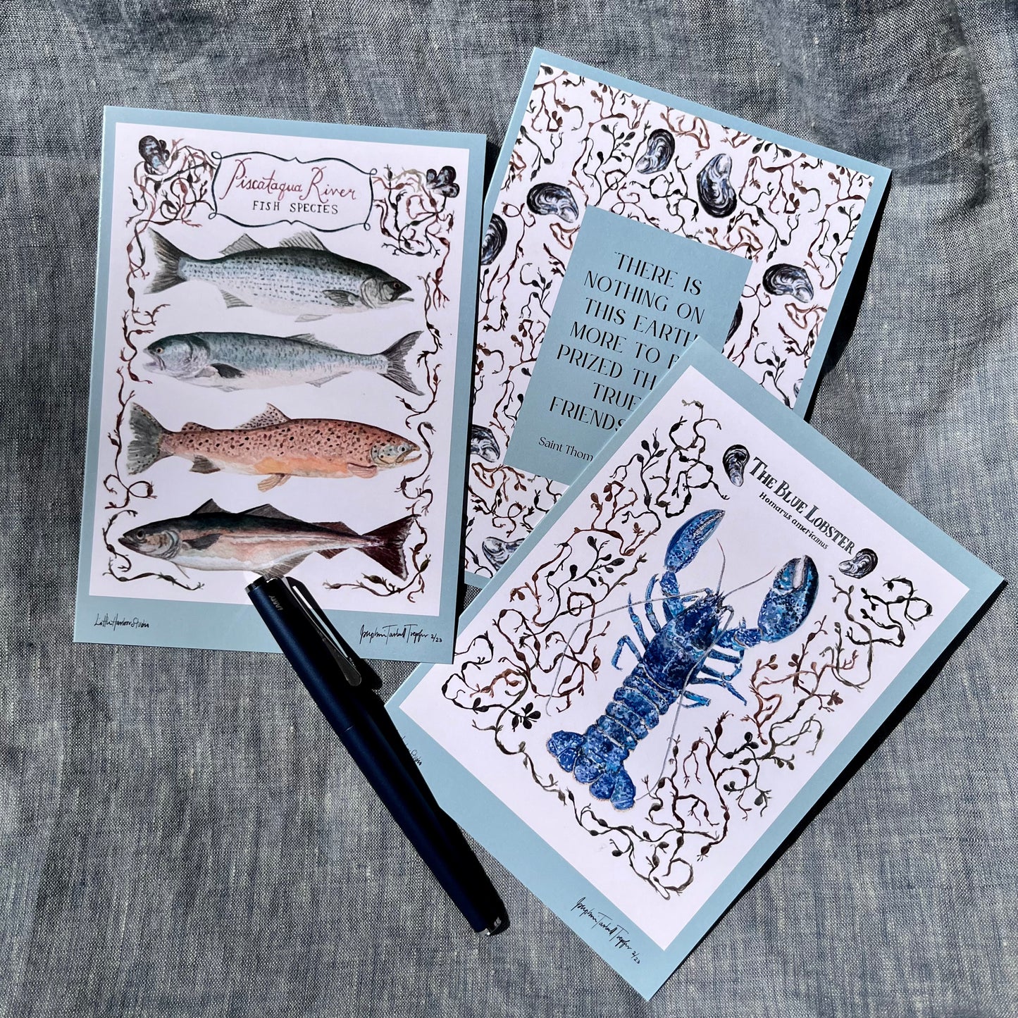 Fold over hand painted greeting card with blue lobster, seaweed, and clams.